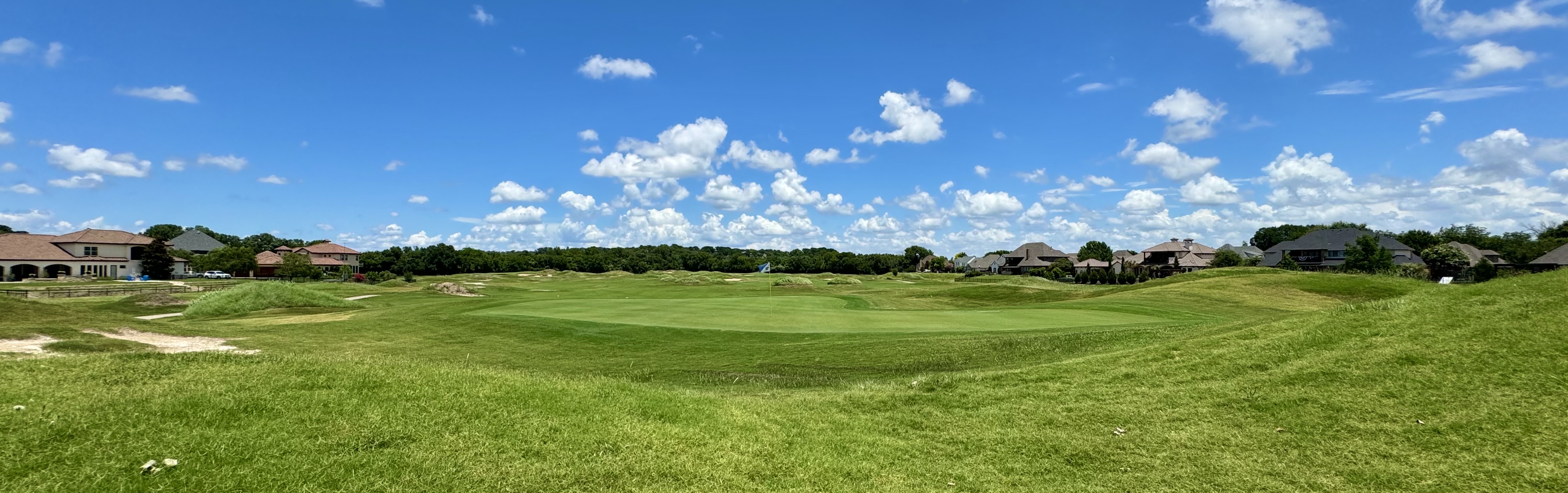 Image of golf ball on tee on grass.